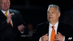 Hungary's Prime Minister Viktor Orban acknowledges cheering supporters during an election night rally in Budapest, Hungary, Sunday, April 3, 2022.