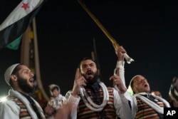 People celebrate as families who were displaced in the war between opposition groups and the Assad regime return to their homes in Damascus, Syria, on Jan. 8, 2025.