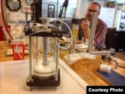 PATH employee Mike Eisenstein with a collection of infusion pump prototypes in the company’s Seattle workshop, December 2016. (T. Furtwangler/PATH)