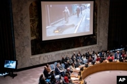 FILE - Images of the devastation in Ukraine are displayed during a meeting of the U.N. Security Council, Tuesday, April 5, 2022, at United Nations headquarters.