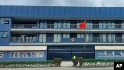FILE - The Chinese national flag flies outside the Chinese Embassy in Honiara, Solomon Islands, April 1, 2022. (AP Photo/Charley Piringi)