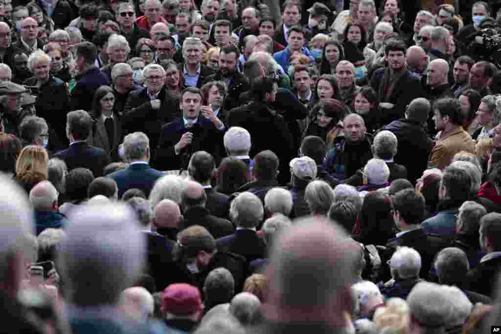 Incumbent French President Emmanuel Macron and centrist candidate for reelection addresses a crowd as he visits Spezet, Brittany.