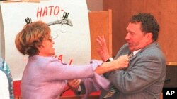 FILE - Russian lawmaker Yevgeniya Tishkovskaya, a deputy from the group called New Regional Politics, punches Russia's nationalist Liberal Democratic Party leader Vladimir Zhirinovsky during an emergency session of the Duma in Moscow, Sept. 9, 1995.