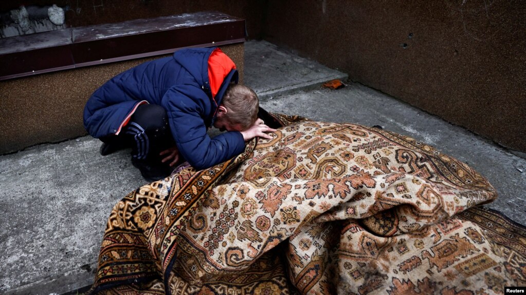 乌克兰布查镇的一个男子在哀悼他的一名被俄军杀死的朋友。（2022年4月5日）(photo:VOA)