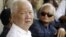 Former Khmer Rouge leaders Khieu Samphan, left, and Nuon Chea, right, look on during the funeral for Khieu Ponnary, the first wife of Khmer Rouge leader Pol Pot, in 2003. 