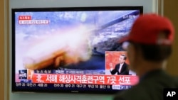 A man watches a television news program reporting about North Korea's plan to conduct live-fire drills, at a Seoul train station in Seoul, South Korea, Monday, March 31, 2014.