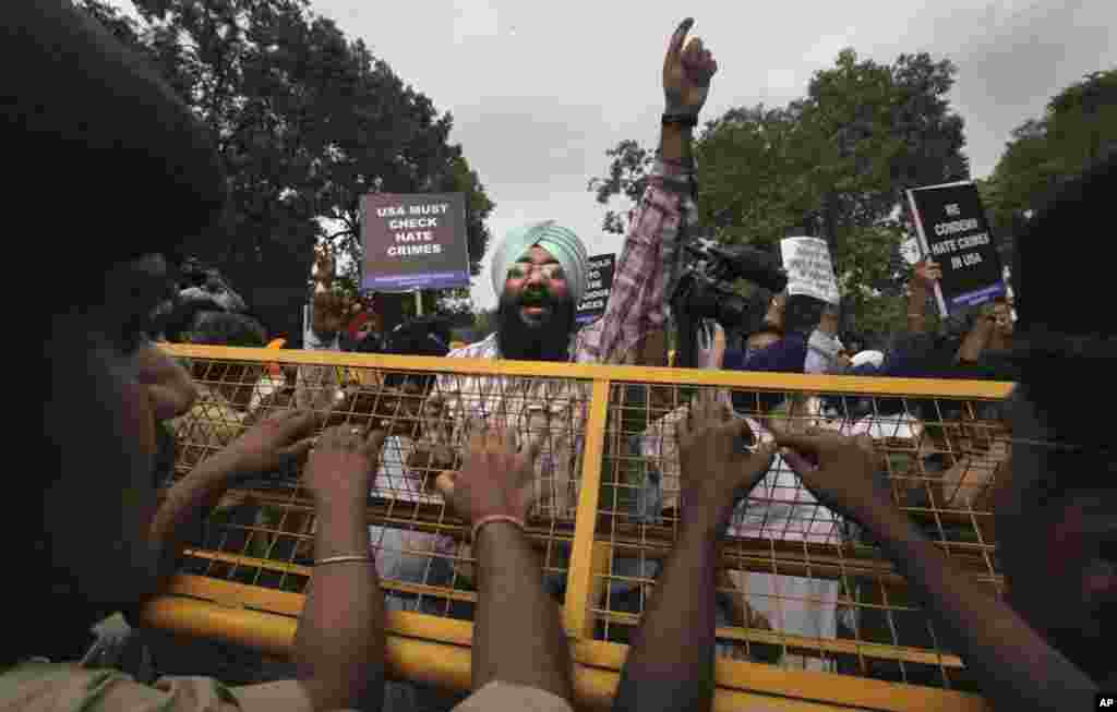 Indian Sikhs protest in New Delhi against Sunday's shooting in the U.S. Indian Prime Minister Manmohan Singh said Monday that he was shocked and saddened by the attack.