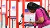 A voter fills out her ballot during the Kentucky Primary at the Kentucky Exposition Center in Louisville, Ky., June 23, 2020.