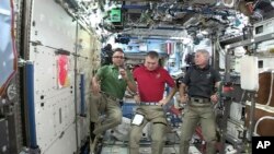 Joe Acaba, left, the first astronaut of Puerto Rican heritage, talks during an interview alongside Italy's Paolo Nespoli, center, and American Mark Vande Hei from the International Space Station on Sept. 20, 2017. Acaba offered words of comfort to Puerto Ricans enduring the wrath of Hurricane Maria. 