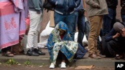 FILE - In this Sept. 1, 2015 file photo, a young child waits in line at a migrant reception center in Brussels. Belgian migration minister Theo Francken on Dec. 6, 2018, said he wants no part of a United Nations pact on safe and orderly migration.