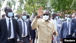 President Patrice Talon greets his supporters after casting his ballot at a polling station in Cotonou, Benin, April 11, 2021.