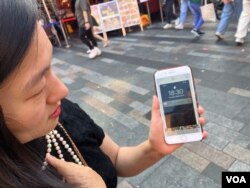 王曉宇向美國之音展示她保存的女王離世時的手機截屏(美國之音/江玉)