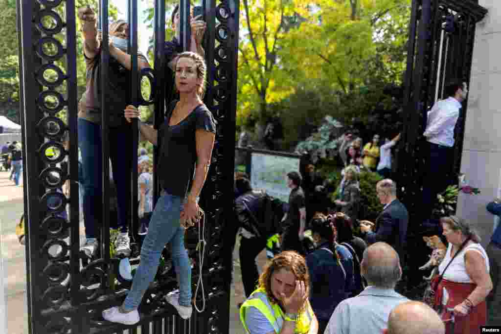 People gather in London to watch the coffin of Queen Elizabeth II being transported from Buckingham Palace to the Houses of Parliament.