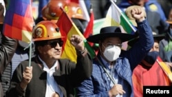 El presidente de Bolivia, Luis Arce Catacora, y el expresidente de Bolivia, Evo Morales, levantan los puños mientras marchan con simpatizantes del partido boliviano MAS, trabajadores y cocaleros para expresar su apoyo al gobierno de Arce, en La Paz, Bolivia, 25 de agosto de 2022.