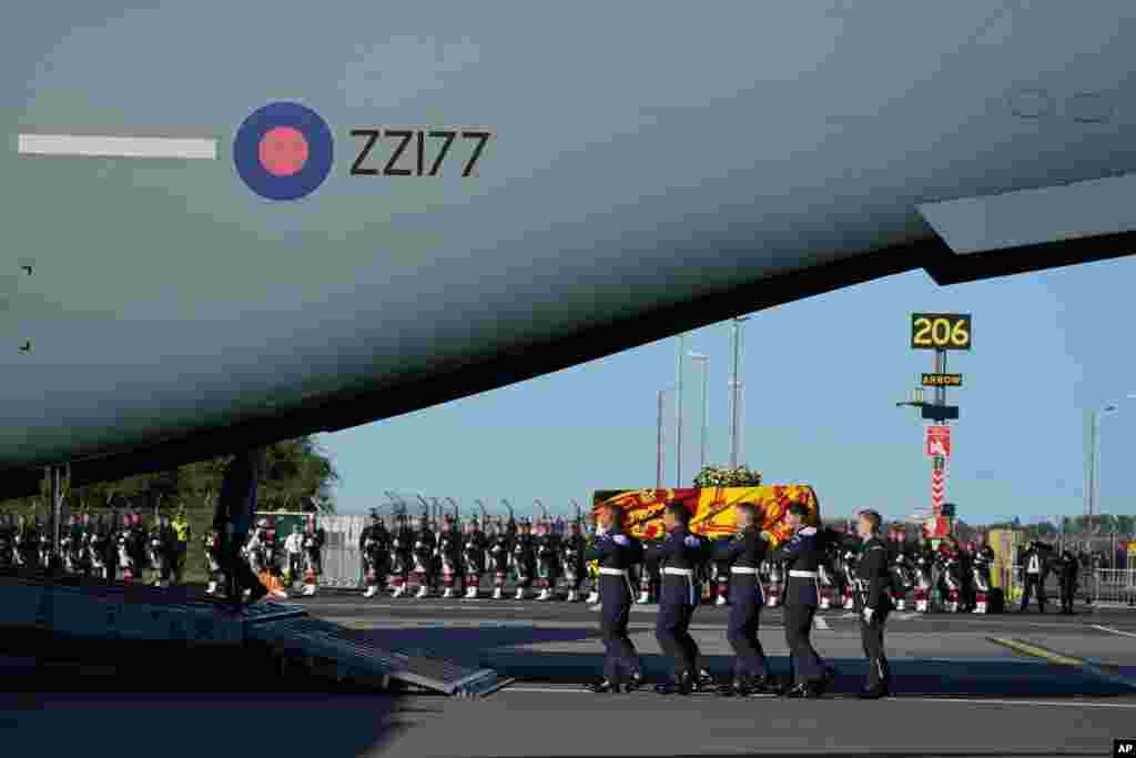 The coffin of Queen Elizabeth II is carried to the RAF aircraft at Edinburgh Airport, Sept. 13, 2022, for the final journey from Scotland in a Royal Air Force plane to London.