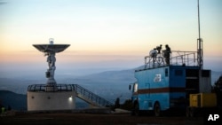 File--The national public broadcaster EBC broadcasts the launch of Ethiopia's very first micro-satellite (ETRSS-1) at the Entoto Observatory on the outskirts of the capital Addis Ababa, Friday Dec. 20, 2019. 