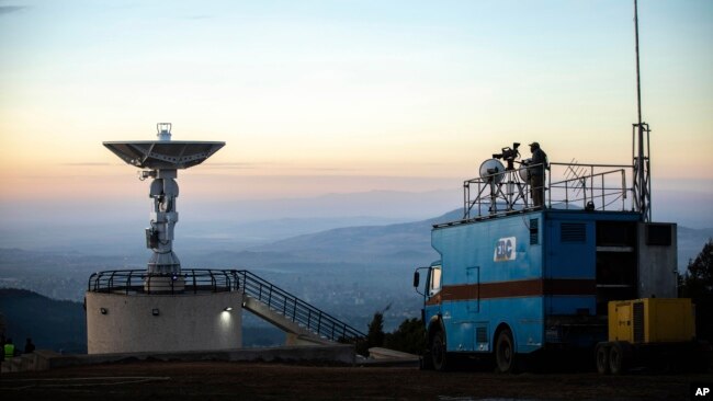 File--The national public broadcaster EBC broadcasts the launch of Ethiopia's very first micro-satellite (ETRSS-1) at the Entoto Observatory on the outskirts of the capital Addis Ababa, Friday Dec. 20, 2019. 