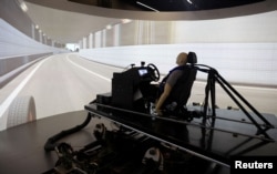 AB Dynamics staff run a demonstration of the advanced Vehicle Driving Simulator (aVDS) in Bradford on Avon, Britain, June 20, 2022. (REUTERS/Matthew Childs)