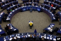 Dressed in the colors of Ukraine, European Union Commission Chief Ursula von der Leyen delivers her State of the European Union address, Sept. 14, 2022 at the European Parliament in Strasbourg, eastern France.