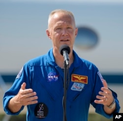 FILE - NASA astronaut Doug Hurley speaks at a news conference after he arrives at the Kennedy Space Center in Cape Canaveral, Fla., May 20, 2020. (Bill Ingalls/NASA via AP)