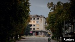 A local resident walks in a street in the town of Izium recently, liberated by the Ukrainian Armed Forces, September 13, 2022. 