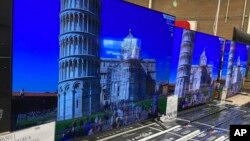 FILE - A 65-inch television is shown at a warehouse store in Lone Tree, Colorado, June 17, 2021. "Buy now, pay later" loans allow users to pay for items such as electronics and other consumer goods in installments.