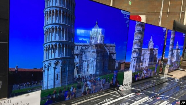 FILE - A 65-inch television is shown at a warehouse store in Lone Tree, Colorado, June 17, 2021.