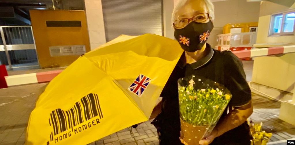 社运人士王婆婆手持鲜花及黄色雨伞悼念英女皇 (美国之音/汤慧云)(photo:VOA)