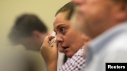 Erica Lafferty-Garbatini, daughter of Sandy Hook Principal Dawn Hochsprung, wipes away a tear as she listens to FBI Agent William Aldenberg describe his experience of moving through Sandy Hook Elementary School during his response to the shooting at the school.