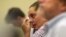 Erica Lafferty-Garbatini, daughter of Sandy Hook Principal Dawn Hochsprung, wipes away a tear as she listens to FBI Agent William Aldenberg describe his experience of moving through Sandy Hook Elementary School during his response to the shooting at the school.