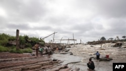 Des jeunes se lavent dans le fleuve Congo près des célèbres chutes de Wagenya à Kisangani, dans la province de Tshopo, au nord-est de la RDC, le 30 août 2022.