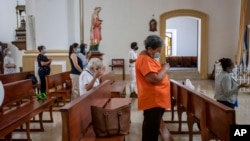 FILE - Faithful attend a Mass at the Cathedral in Matagalpa, Nicaragua, Aug. 19, 2022, after Nicaraguan police raided the residence of a bishop and several priests in an escalation of tensions between the Catholic Church and the government of President Daniel Ortega.
