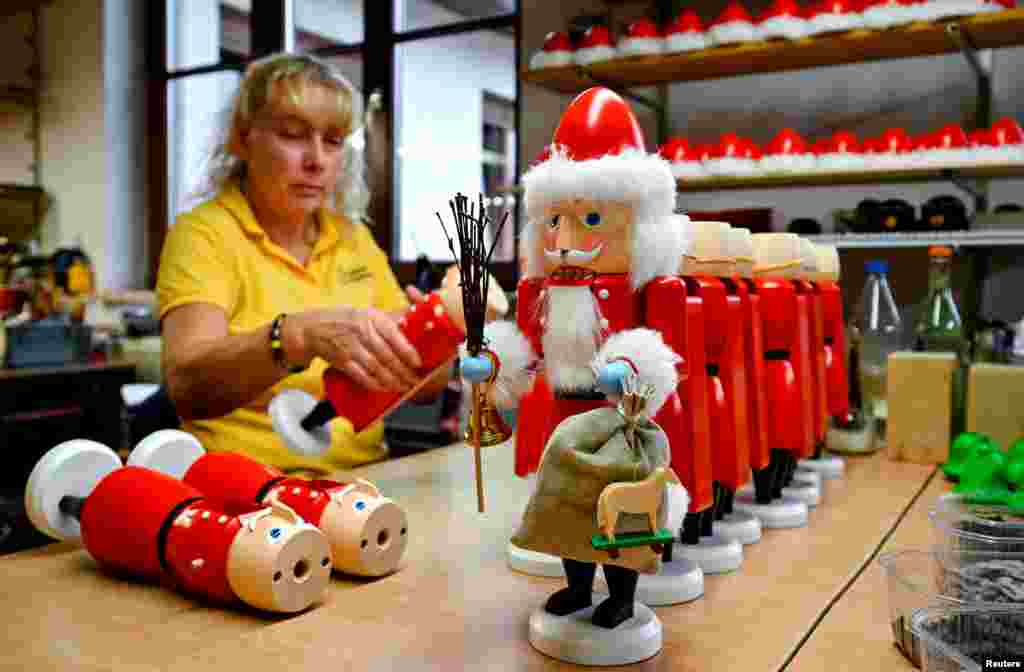 An employee assembles nutcrackers at the workshop of wood art manufacturer Seiffener Volkskunst in Seiffen, Germany.