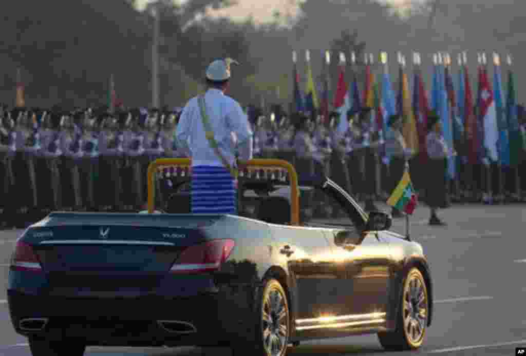 Myanmar's President Thein Sein, standing in an open vehicle, inspect officers and soldiers during a ceremony to mark Myanmar's 67th anniversary of Independence Day in Naypyitaw, Myanmar, Sunday, Jan. 4, 2015. (AP Photo/Gemunu Amarasinghe)