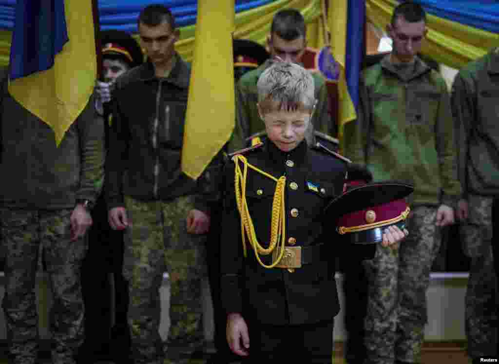 Young military cadets take part in a ceremony to receive their shoulder marks, amid Russia's attack on Ukraine, in Kyiv, Ukraine.