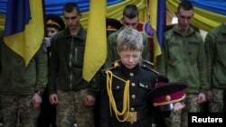 Young military cadets take part in a ceremony to receive their shoulder marks, amid Russia's attack on Ukraine, in Kyiv, Ukraine.