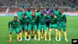 FILE - Cameroon players line up for a photograph prior to the start of the friendly soccer match between South Korea and Cameroon at Seoul World Cup Stadium in Seoul, South Korea, Sept. 27, 2022.