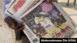 A man sells Senegalese newspapers with headlines of footballer, Sadio Mane's withdrawal from the 2022 World Cup in Dakar, Senegal, November 18, 2022. 