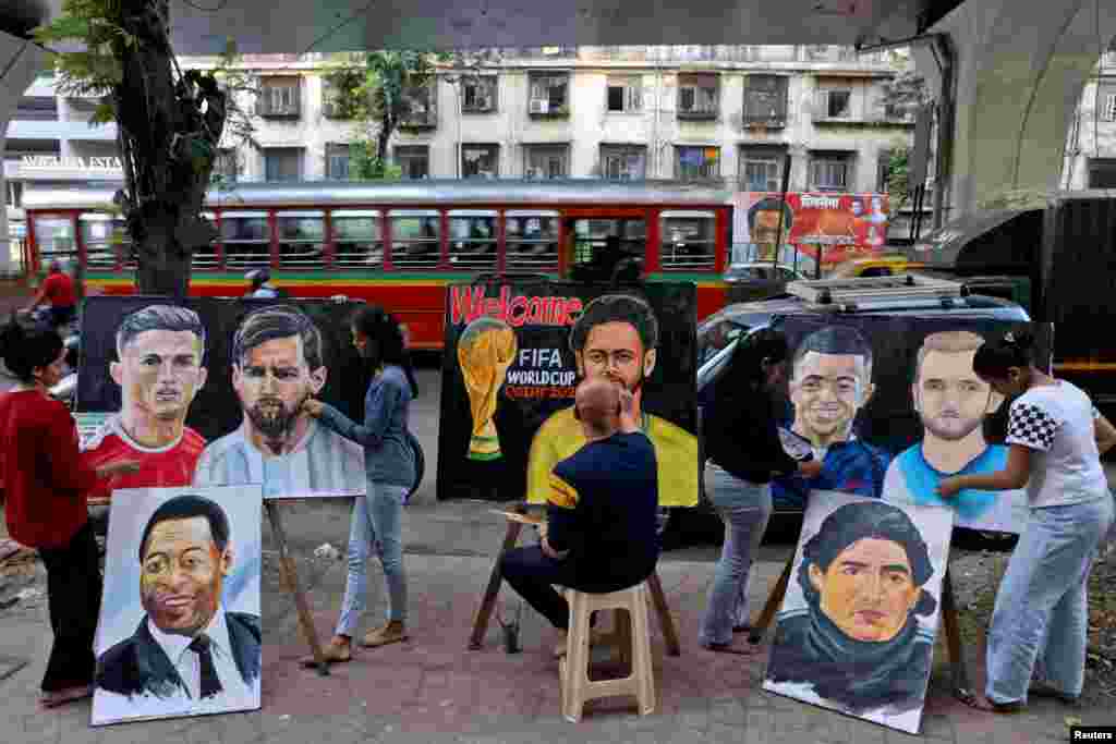 Students work on paintings depicting soccer players Cristiano Ronaldo, Lionel Messi, Pele, Neymar, Kylian Mbappe, Harry Kane and Diego Maradona ahead of FIFA World Cup Qatar 2022, outside an art school in Mumbai, India.