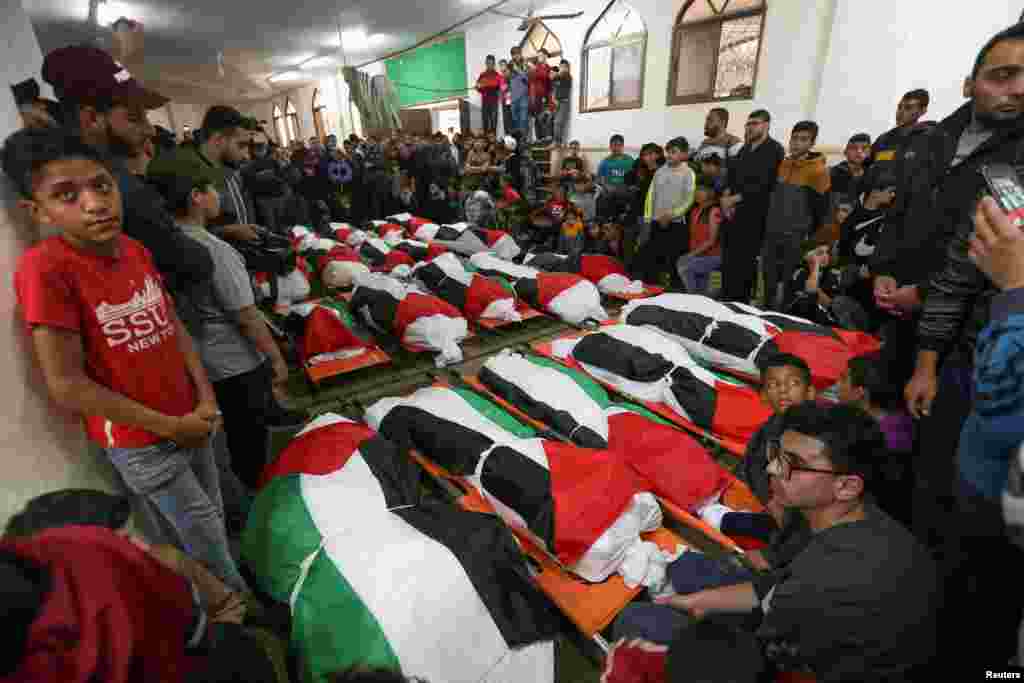 Palestinians attend the funeral of 21 people who were killed in a fire that broke out during a party in the Gaza Strip, according to health and civil emergency officials in the northern Gaza Strip.