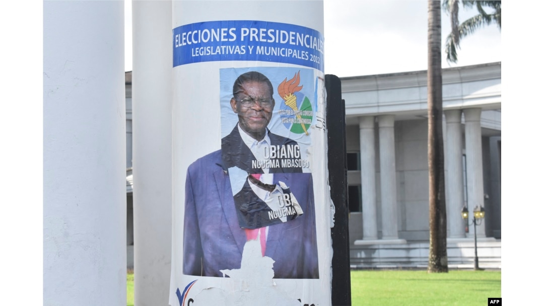 FILE - A campaign poster for Equatorial Guinea President Teodoro Obiang Nguema is pasted over a campaign poster of opponent Essono Ondo Andress, in Malabo, Nov. 17, 2022.