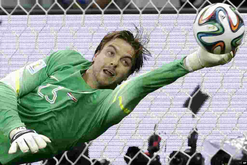 Netherlands&#39; goalkeeper Tim Krul saves the last penalty kick during the World Cup quarterfinal soccer match between the Netherlands and Costa Rica at Arena Fonte Nova in Salvador, Brazil, July 5, 2014.
