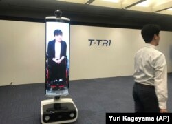 In this Thursday, July 18, 2019, photo, a T-TRI robot is demonstrated before the media at Toyota Motor Corp. headquarters in Tokyo.