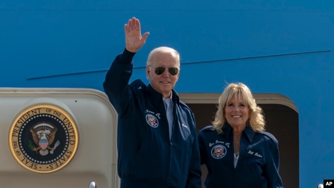 FILE - U.S. President Joe Biden waves as first lady Jill Biden watches standing at the top of the steps of Air Force One before boarding at Andrews Air Force Base, Md., Saturday, Sept. 17, 2022. (AP Photo/Gemunu Amarasinghe, File)