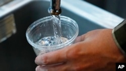 FILE - A cup of water is drawn from a faucet in this illustrative photo taken Sept. 1, 2022.