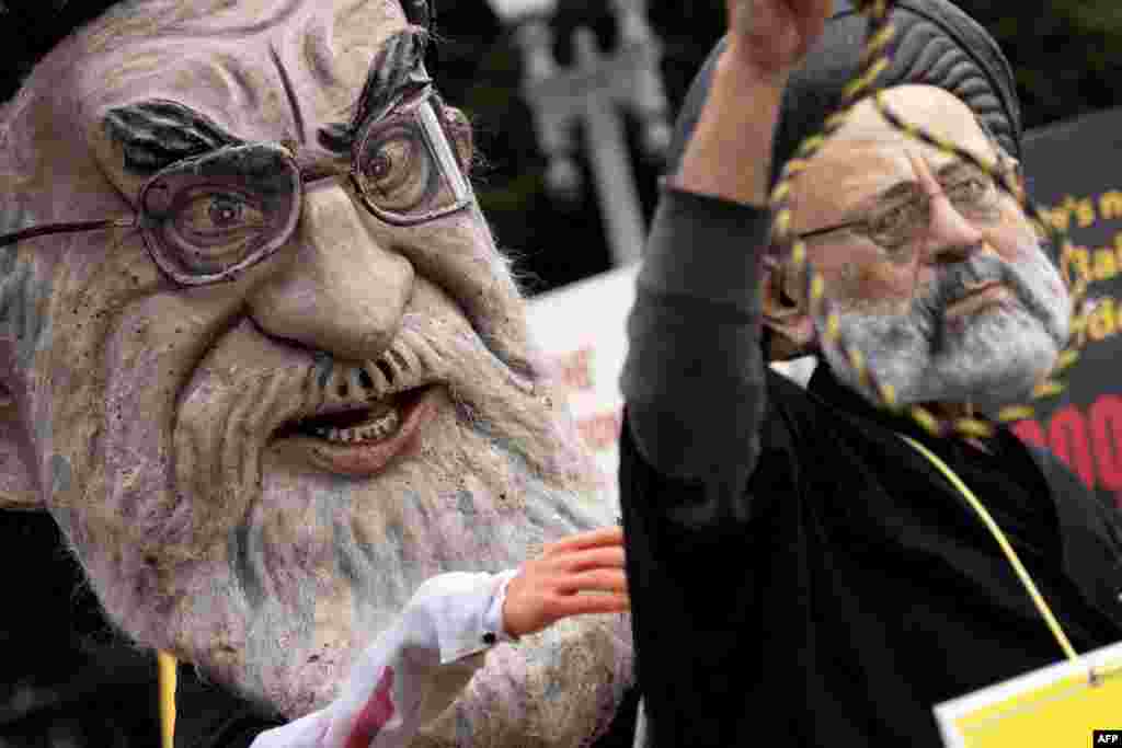 Demonstrators dressed as Iranian President Ebrahim Raisi and Irans Supreme Leader Ali Khamenei rally outside the White House on Sept. 24, 2022.