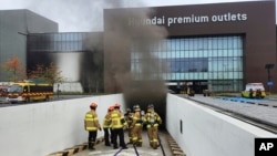 South Korean firefighters work at a shopping mall in Daejeon, South Korea, Monday, Sept. 26, 2022. (Kwak Sang-hun/Newsis via AP)