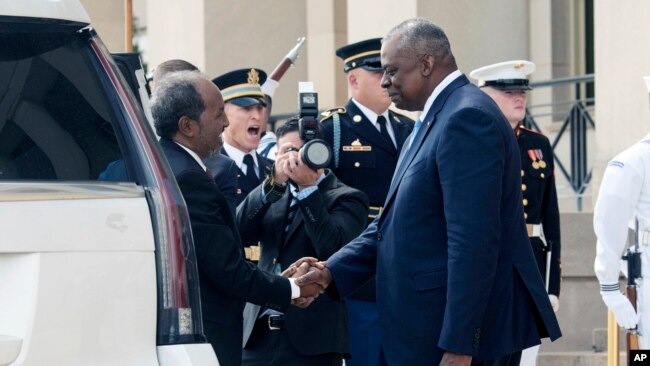 U.S. Defense Secretary Lloyd Austin greets Somali President Hassan Sheik Mohamud, left, during a welcome ceremony at the Pentagon, near Washington, Sept. 15, 2022.