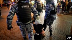 Riot police detain a demonstrator during a protest against mobilization in Moscow, Russia, Sept. 21, 2022.