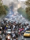 FILE - In this photo obtained by the AP outside Iran, protesters chant slogans during a protest over the death of a woman detained by the morality police, in Tehran, Iran, Sept. 21, 2022.